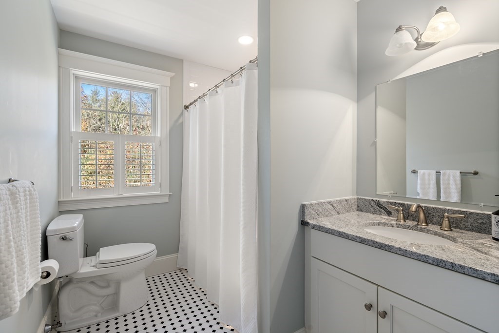 33 Centre Street Dover, MA 02030 - Photo 17 of 32 a bathroom with a granite countertop sink toilet a mirror and shower