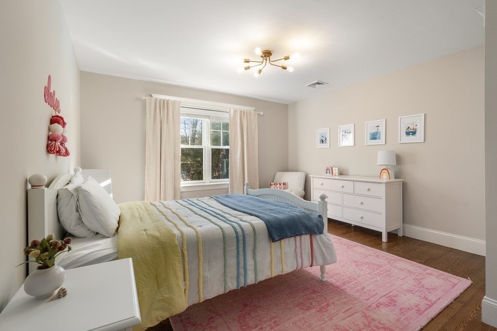 33 Centre Street Dover, MA 02030 - Photo 18 of 32 a bedroom with a bed and wooden floor