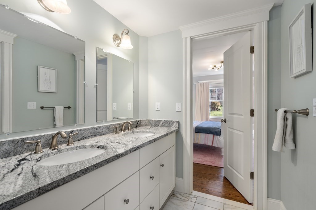 33 Centre Street Dover, MA 02030 - Photo 19 of 32 a spacious bathroom with a granite countertop sink and a mirror