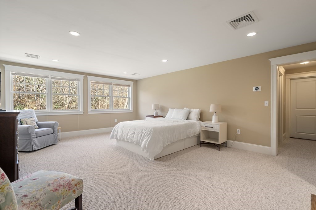 33 Centre Street Dover, MA 02030 - Photo 21 of 32 a spacious bedroom with a bed and a couch
