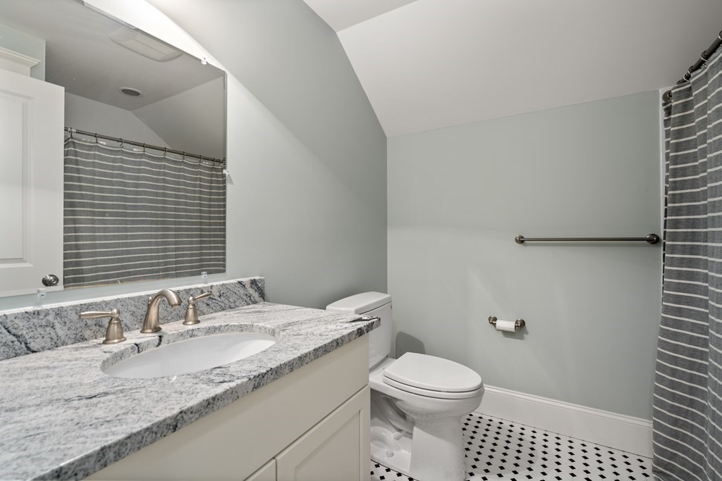 33 Centre Street Dover, MA 02030 - Photo 22 of 32 a bathroom with a granite countertop sink a toilet and a mirror