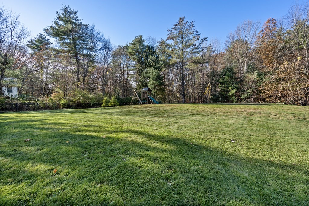 33 Centre Street Dover, MA 02030 - Photo 29 of 32 a view of a grassy field with trees in the background