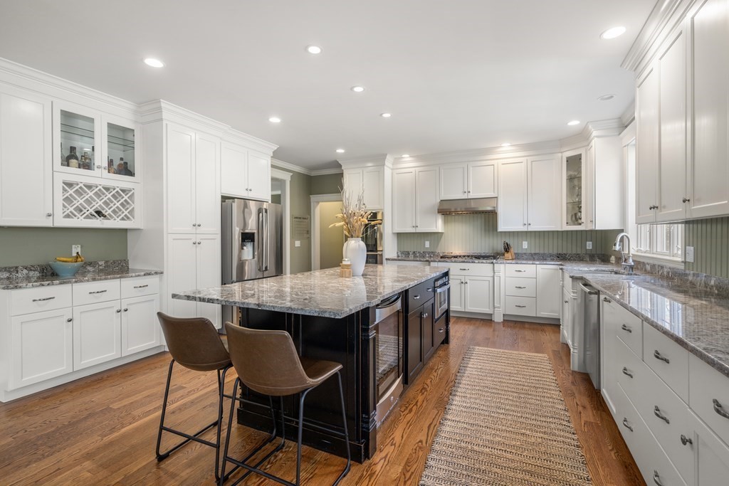 33 Centre Street Dover, MA 02030 - Photo 5 of 32 a large kitchen with kitchen island granite countertop lots of white cabinets appliances and a dining table