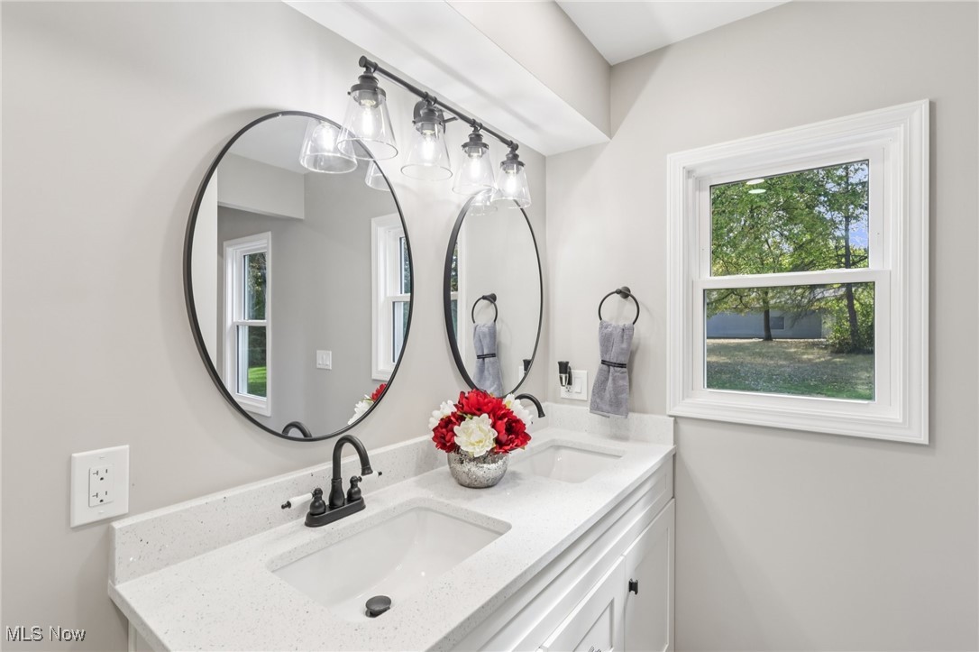 8015 Fairmount Road Novelty, OH 44072 - Photo 36 of 50 Master bathroom featuring double vanity, recessed lighting, and newly tiled, walk-in shower