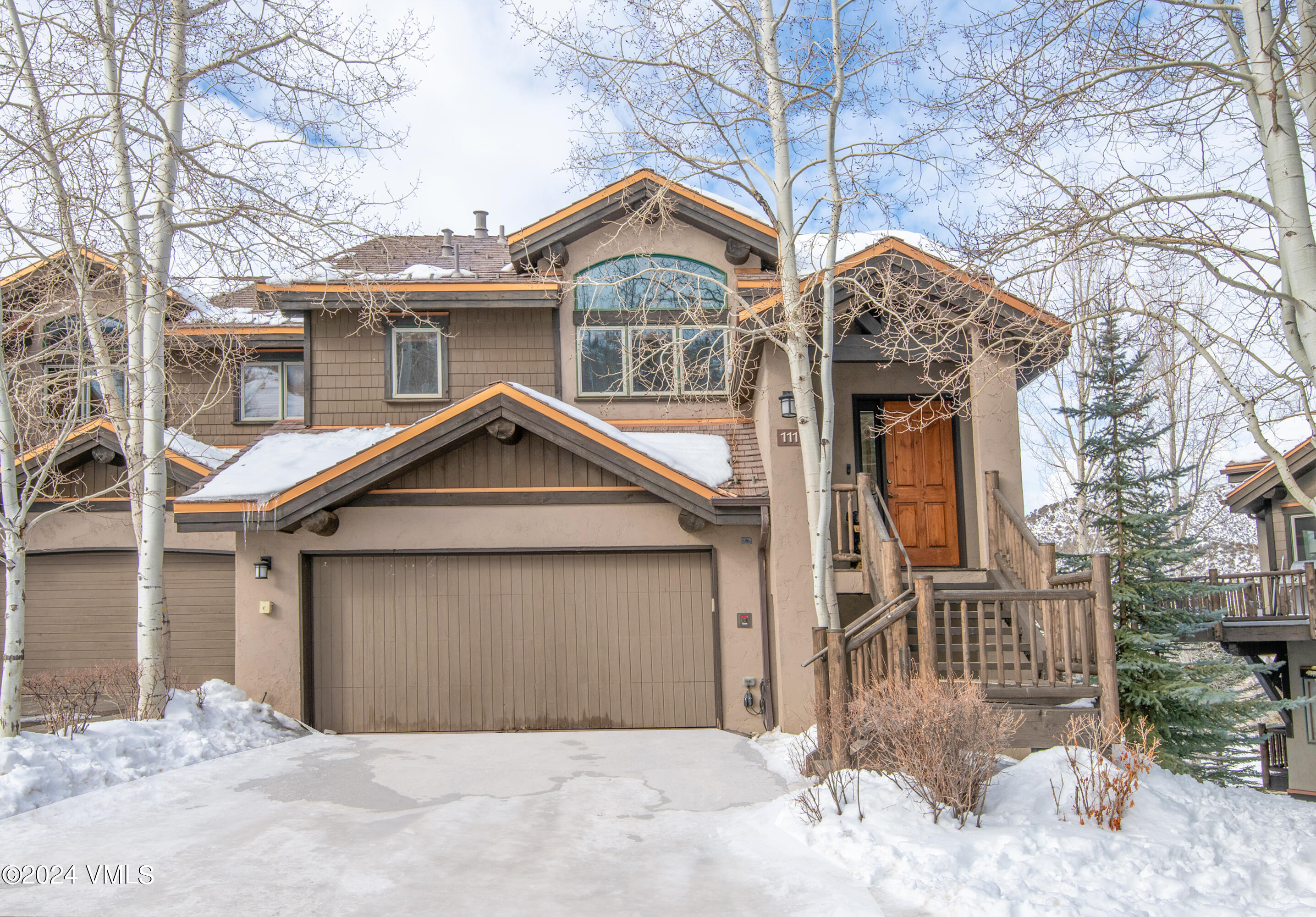 111 Knudson Ranch Road Edwards, CO 81632 - Photo 1 of 31 a front view of a house with a yard and garage