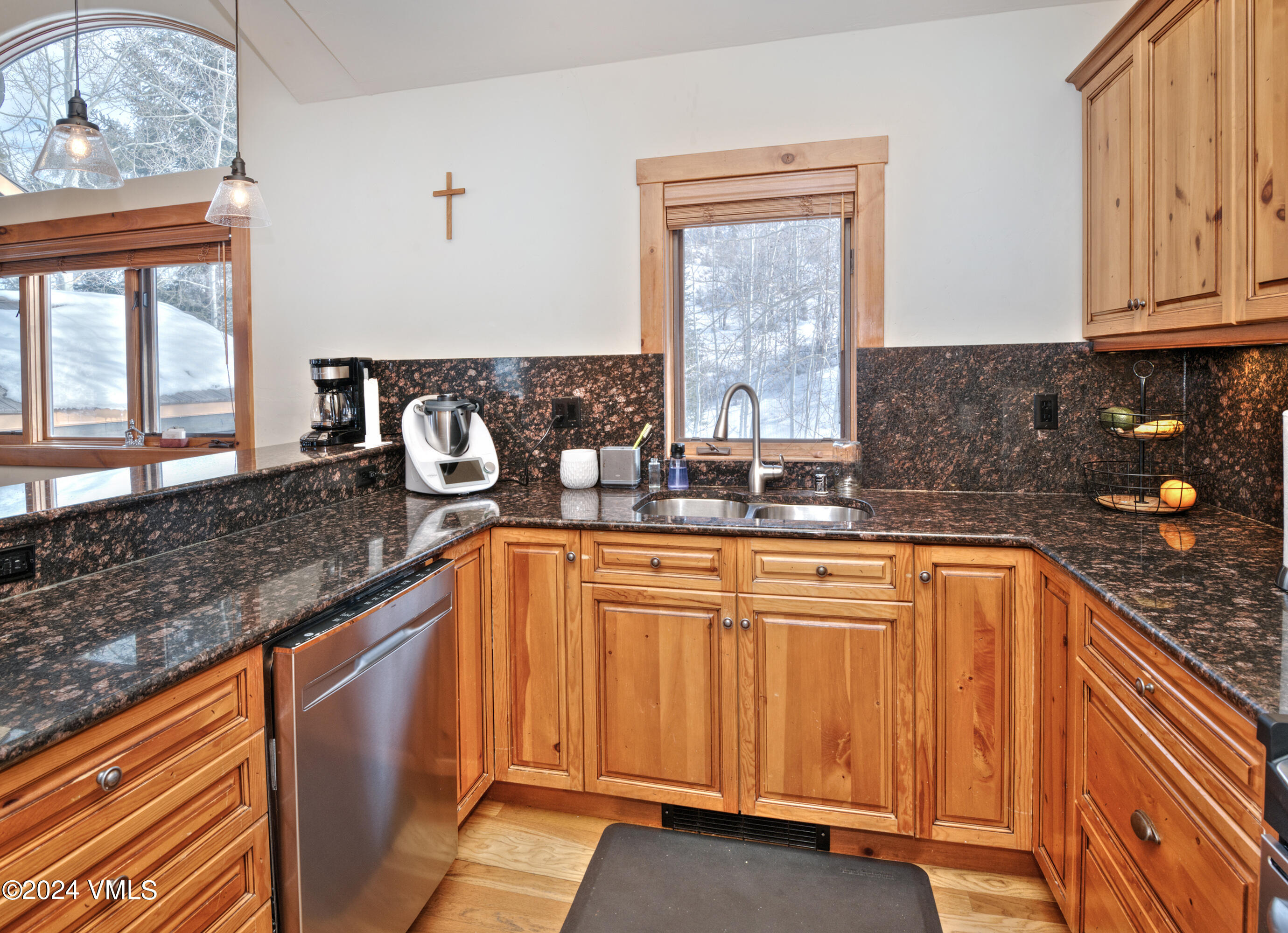 111 Knudson Ranch Road Edwards, CO 81632 - Photo 12 of 31 a kitchen with granite countertop stainless steel appliances a sink window and cabinets