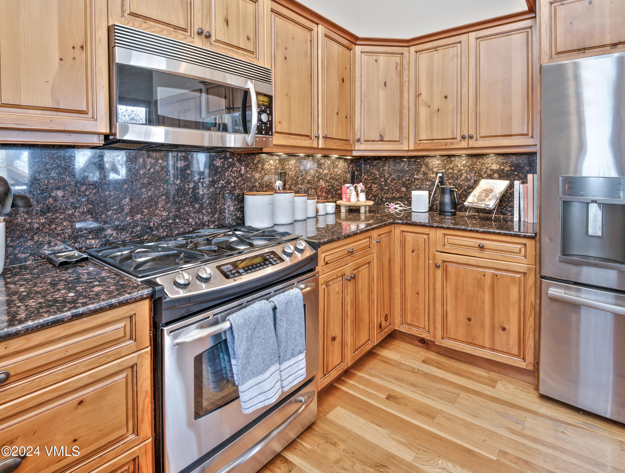 111 Knudson Ranch Road Edwards, CO 81632 - Photo 13 of 31 a kitchen with stainless steel appliances granite countertop a stove a sink and a refrigerator