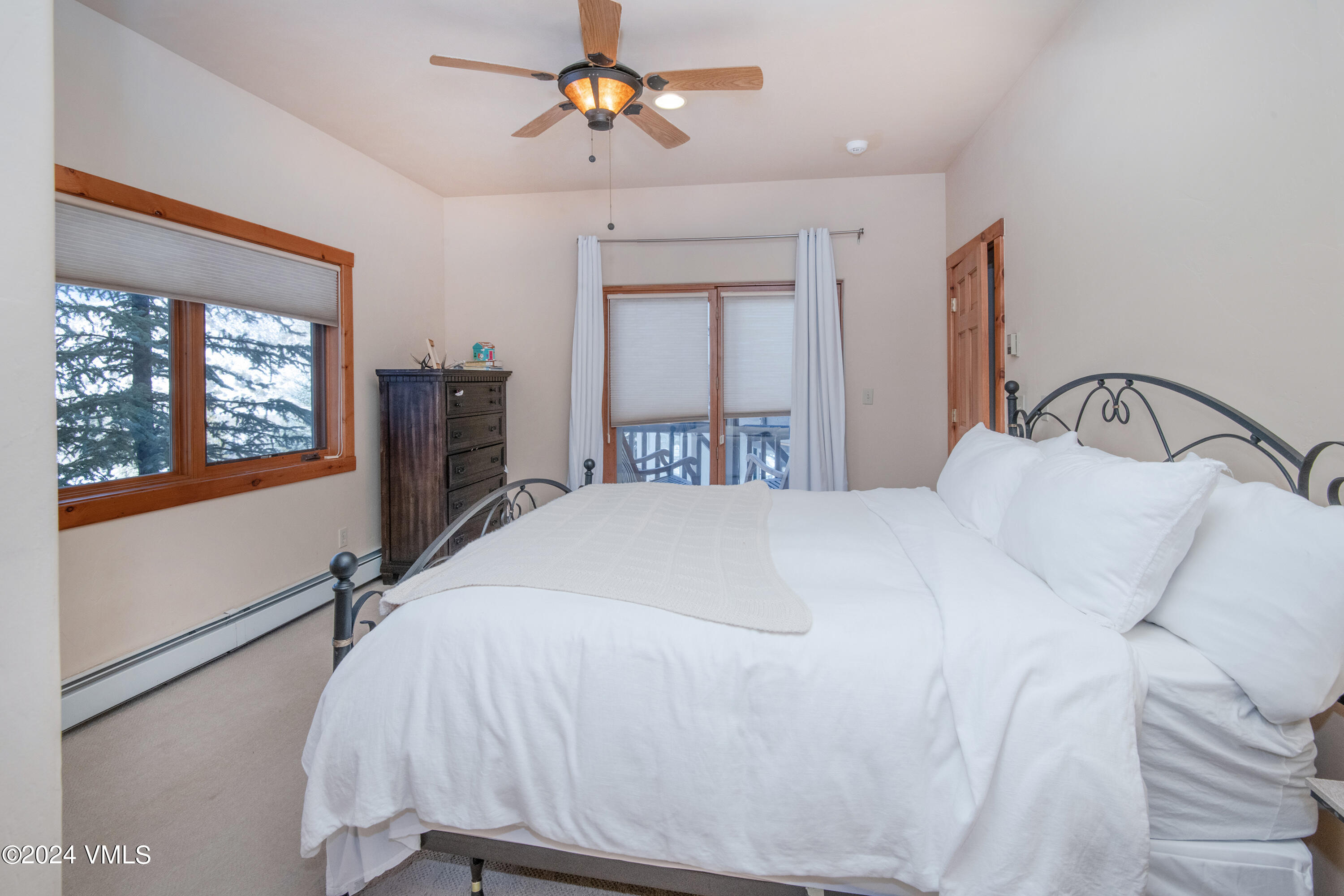111 Knudson Ranch Road Edwards, CO 81632 - Photo 17 of 31 a bedroom with a large bed and a large window