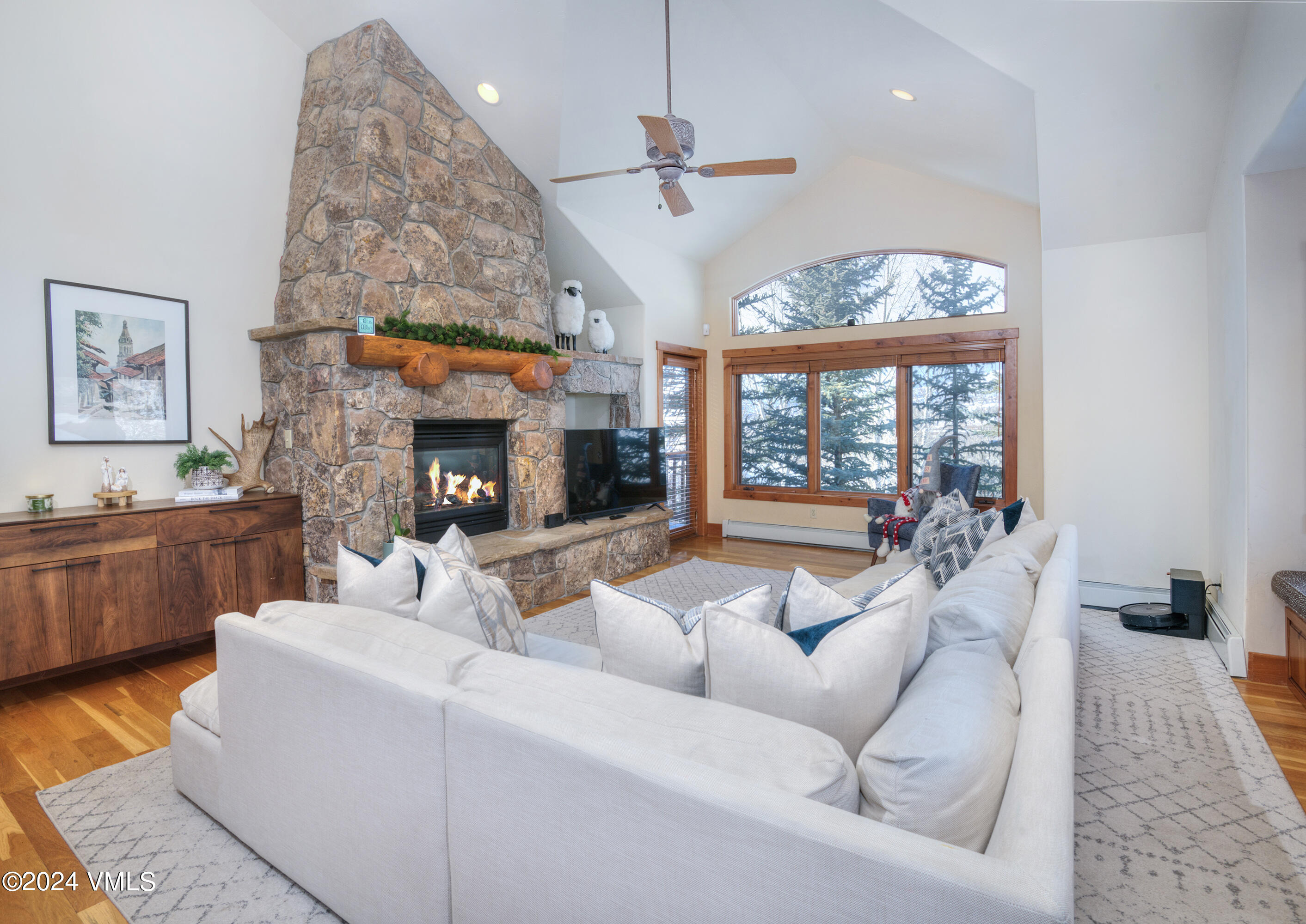 111 Knudson Ranch Road Edwards, CO 81632 - Photo 2 of 31 a living room with fireplace furniture and a large window