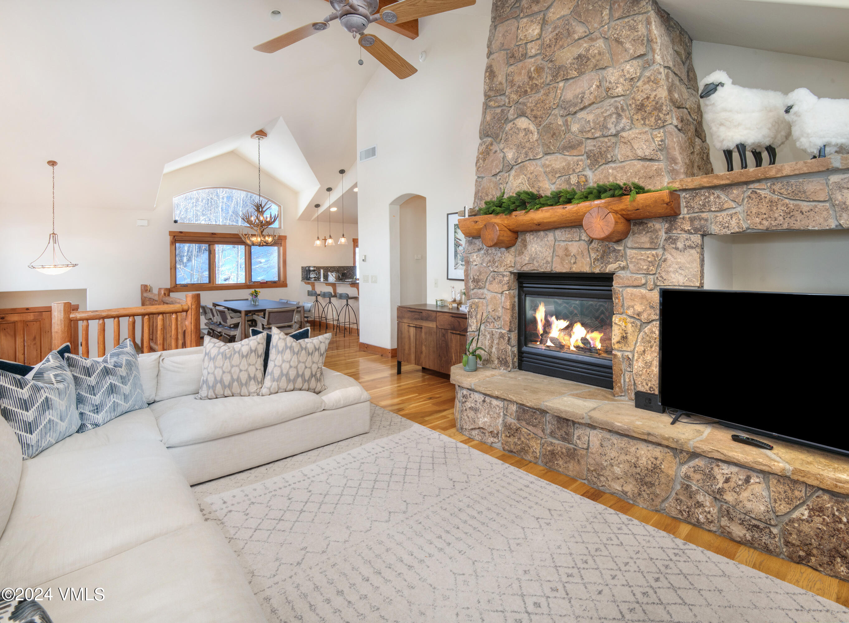 111 Knudson Ranch Road Edwards, CO 81632 - Photo 4 of 31 a living room with furniture a flat screen tv and a fireplace