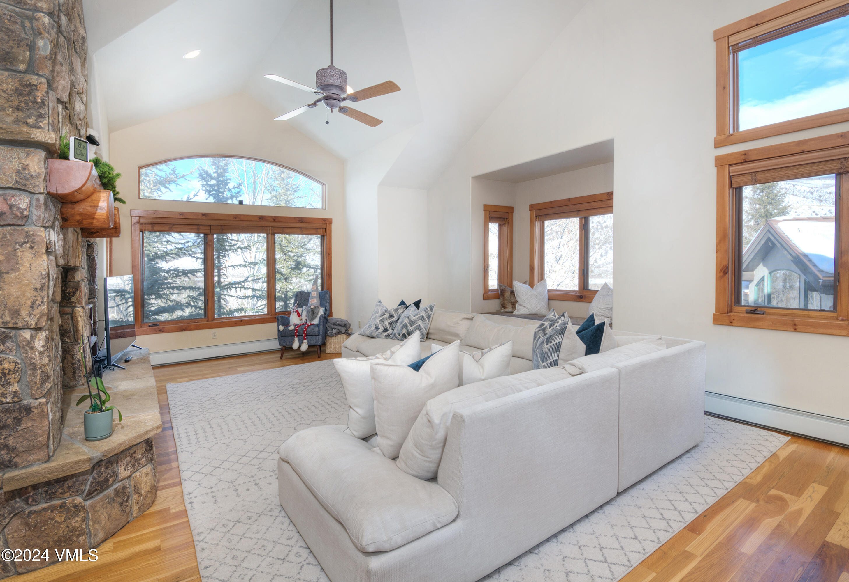 111 Knudson Ranch Road Edwards, CO 81632 - Photo 6 of 31 a living room with furniture a large window and a chandelier