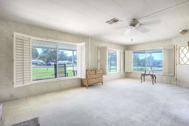 a living room with furniture and a large window with outer view