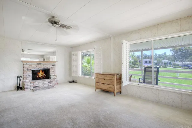 an empty room with furniture fireplace and windows
