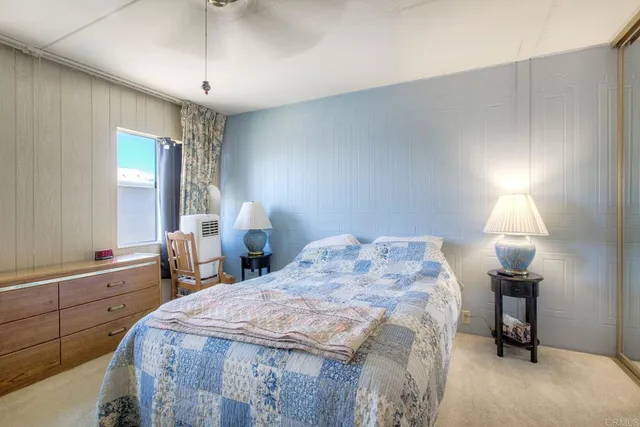 a bedroom with a bed and a lamp on table