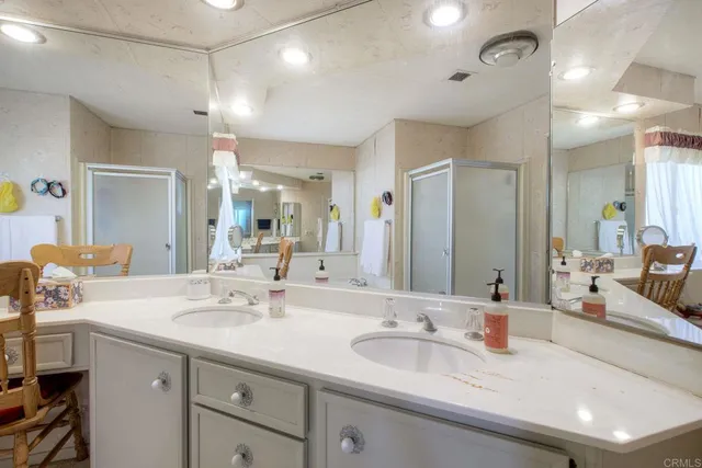 a bathroom with double vanity sinks and a mirror