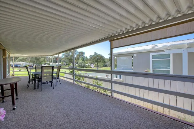 a view of a porch with chairs and backyard