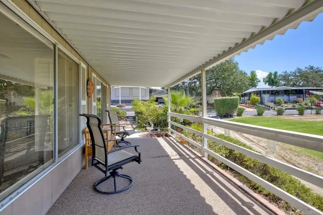 a view of a porch with furniture and garden