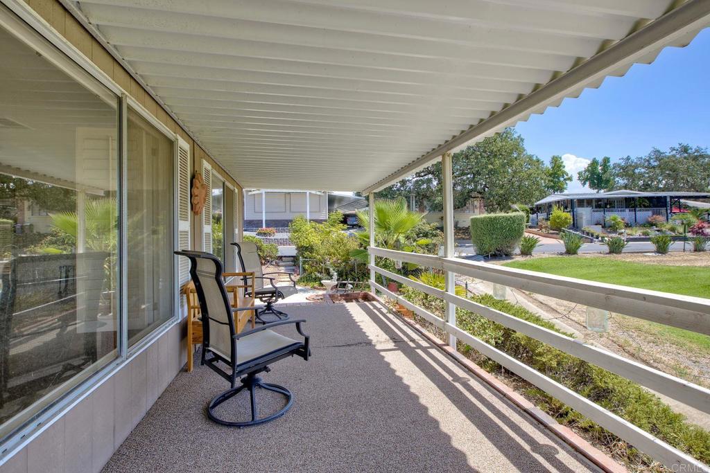 18218 Paradise Mountain Road, Unit 115 Valley Center, CA 92082 - Photo 23 of 27 a view of a porch with furniture and garden
