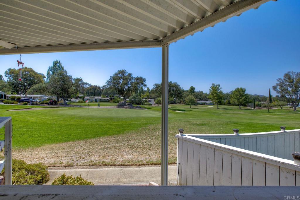 18218 Paradise Mountain Road, Unit 115 Valley Center, CA 92082 - Photo 24 of 27 a view of a wooden deck with a yard