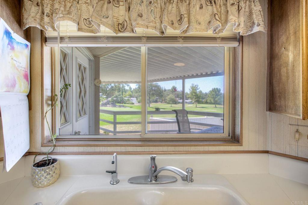 18218 Paradise Mountain Road, Unit 115 Valley Center, CA 92082 - Photo 9 of 27 a bathroom with a sink and a large mirror