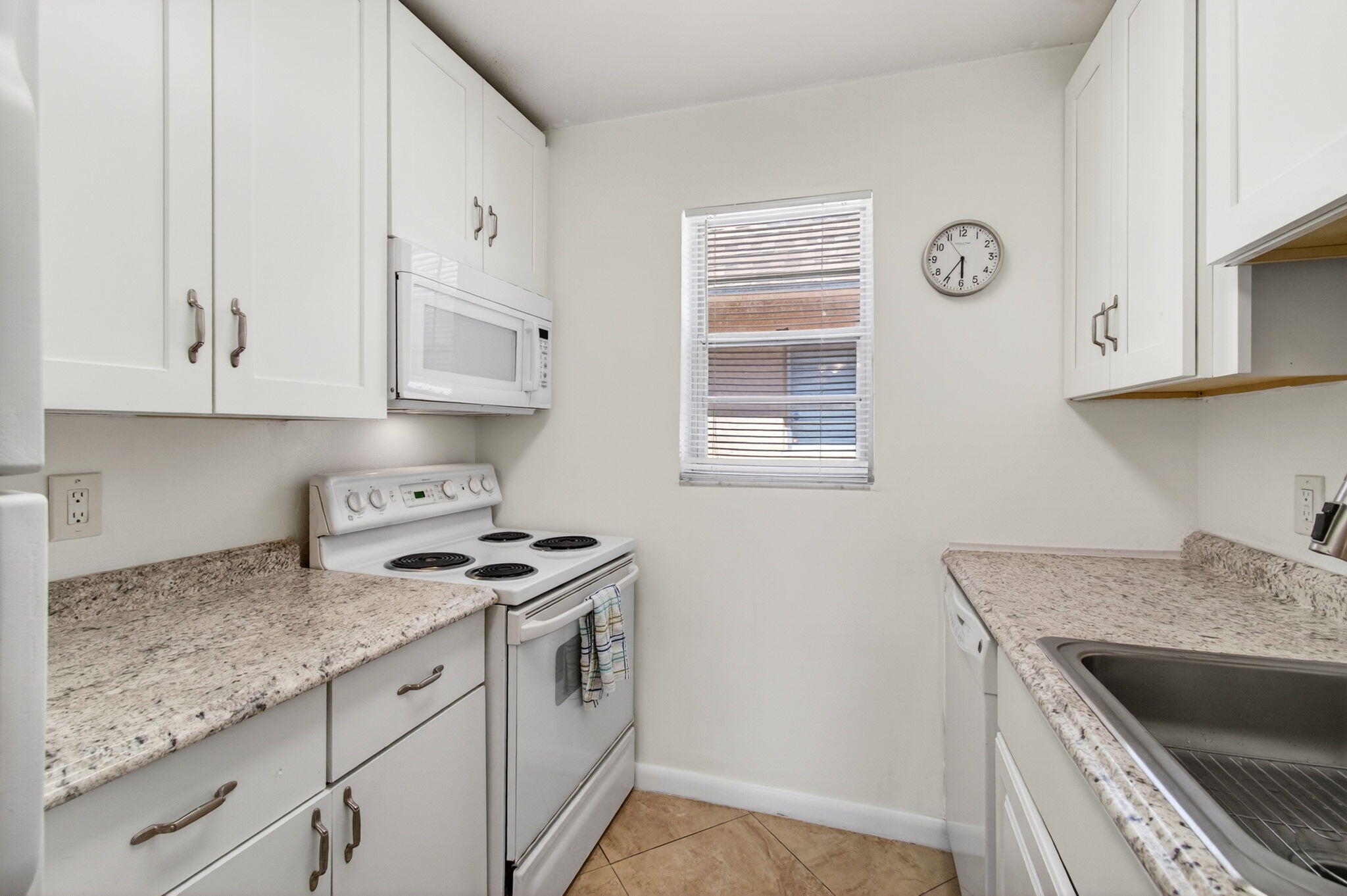 600 Southwest 2nd Avenue, Unit 240 Boca Raton, FL 33432 - Photo 8 of 54 a kitchen with granite countertop white cabinets and a stove