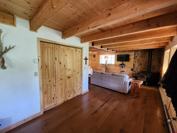 a view of a workspace with furniture and wooden floor