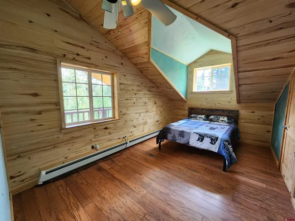 a bedroom with furniture window and wooden floor