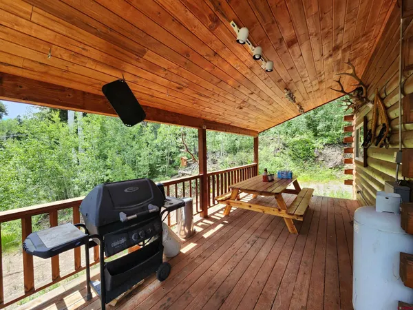 a balcony with wooden floor and outdoor seating