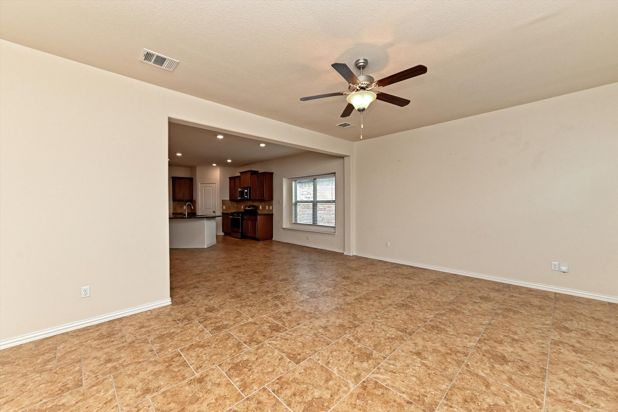 265 Shale Circle Buda, TX 78610 - Photo 13 of 29 Unfurnished living room featuring baseboards and ceiling fan