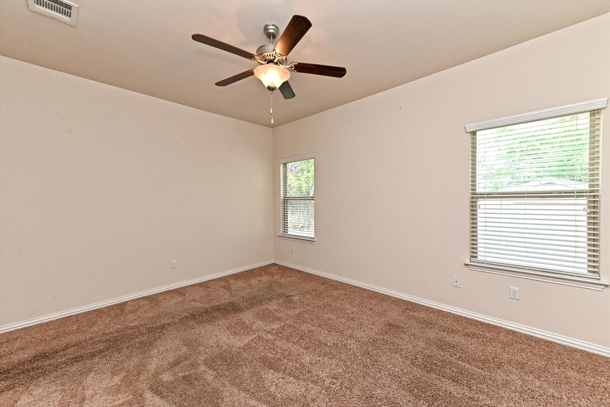 265 Shale Circle Buda, TX 78610 - Photo 16 of 29 Empty room featuring a ceiling fan and dark colored carpet