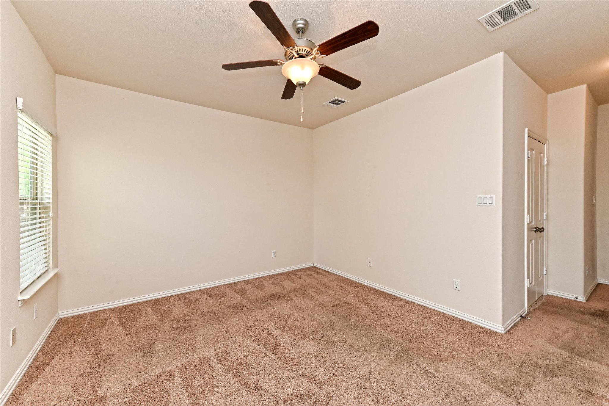 265 Shale Circle Buda, TX 78610 - Photo 18 of 29 Spare room with ceiling fan and light carpet