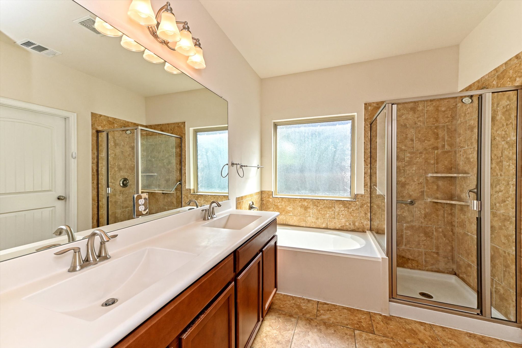 265 Shale Circle Buda, TX 78610 - Photo 20 of 29 Bathroom featuring a stall shower, double vanity, and a bath