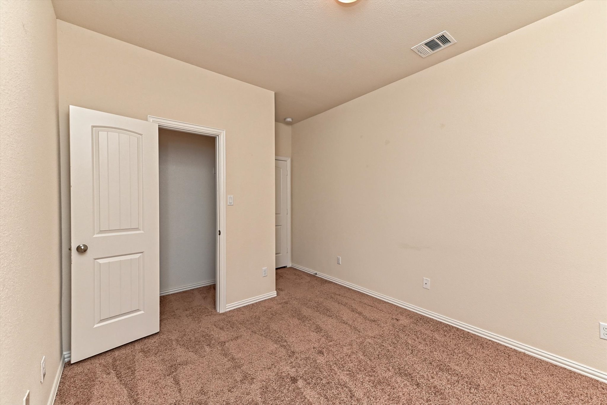 265 Shale Circle Buda, TX 78610 - Photo 22 of 29 Unfurnished bedroom with light carpet and baseboards