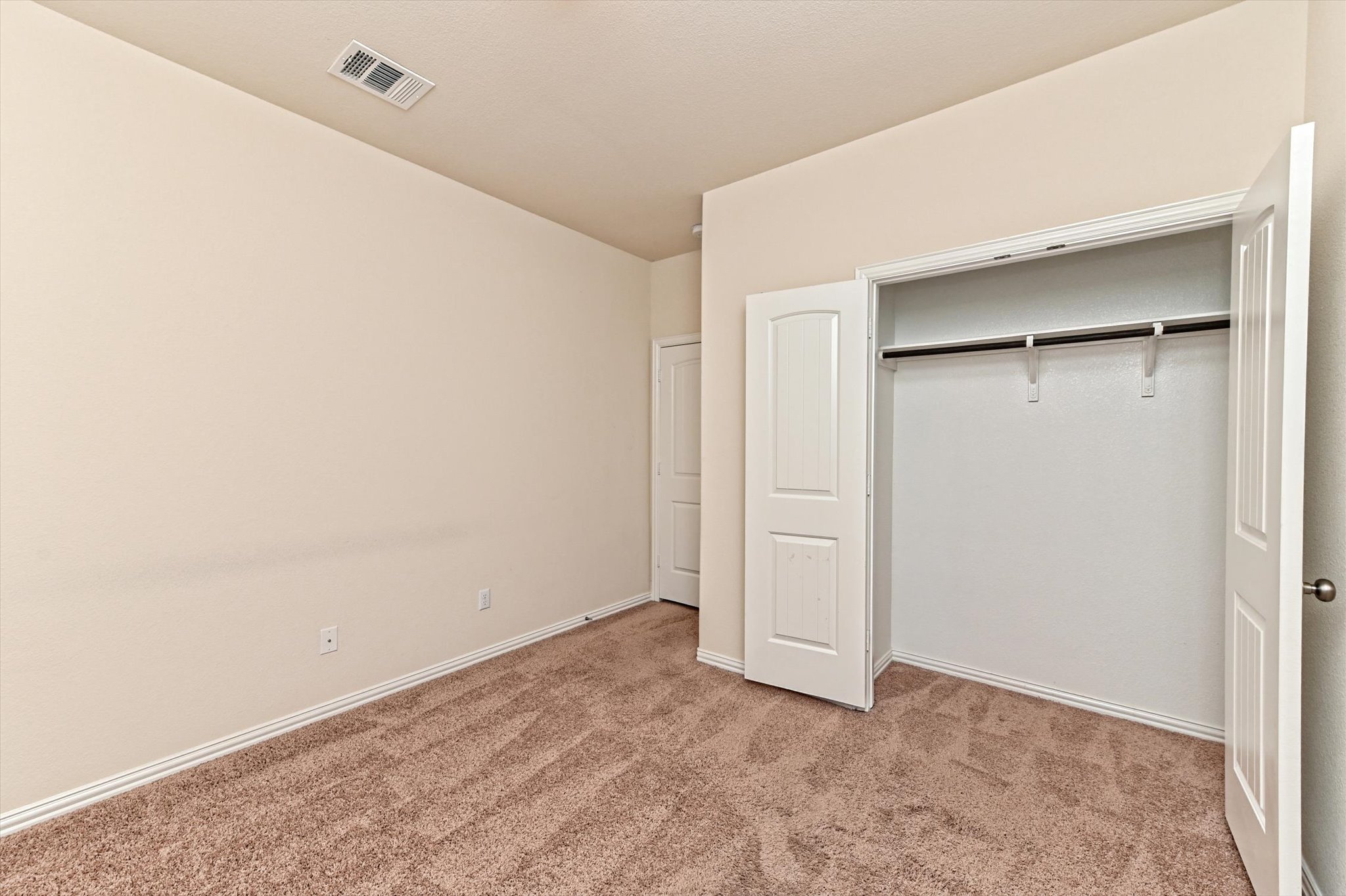 265 Shale Circle Buda, TX 78610 - Photo 25 of 29 Unfurnished bedroom with light colored carpet and a closet