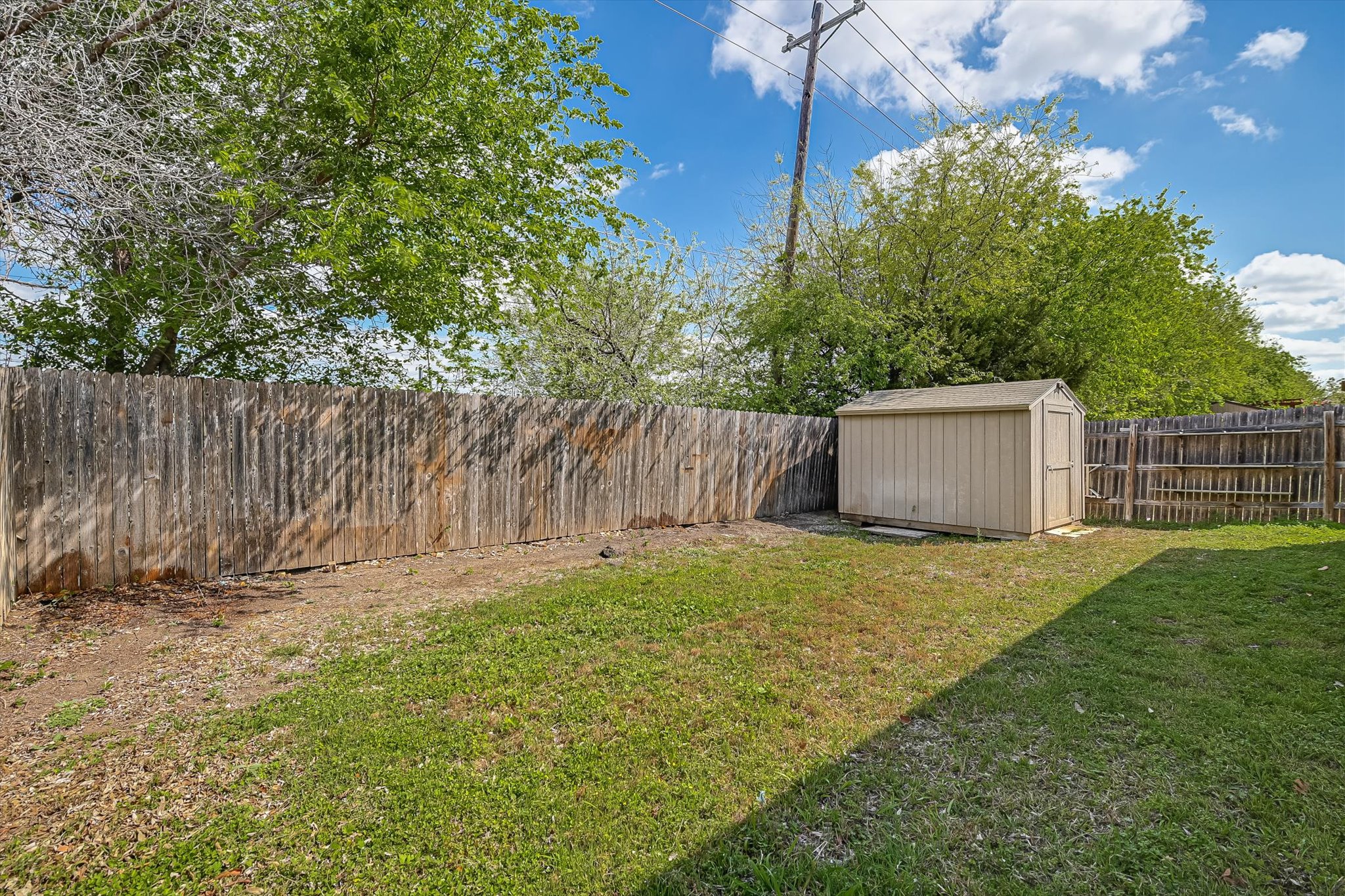 265 Shale Circle Buda, TX 78610 - Photo 29 of 29 Fenced backyard featuring a storage shed