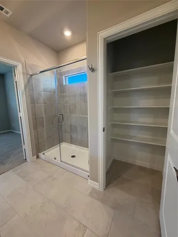 a bathroom with a shower and a sink