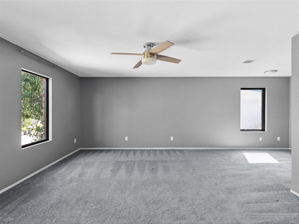 5304 Los Altos Road Fort Worth, TX 76244 - Photo 18 of 30 Spare room with ceiling fan, carpet flooring, and healthy amount of natural light