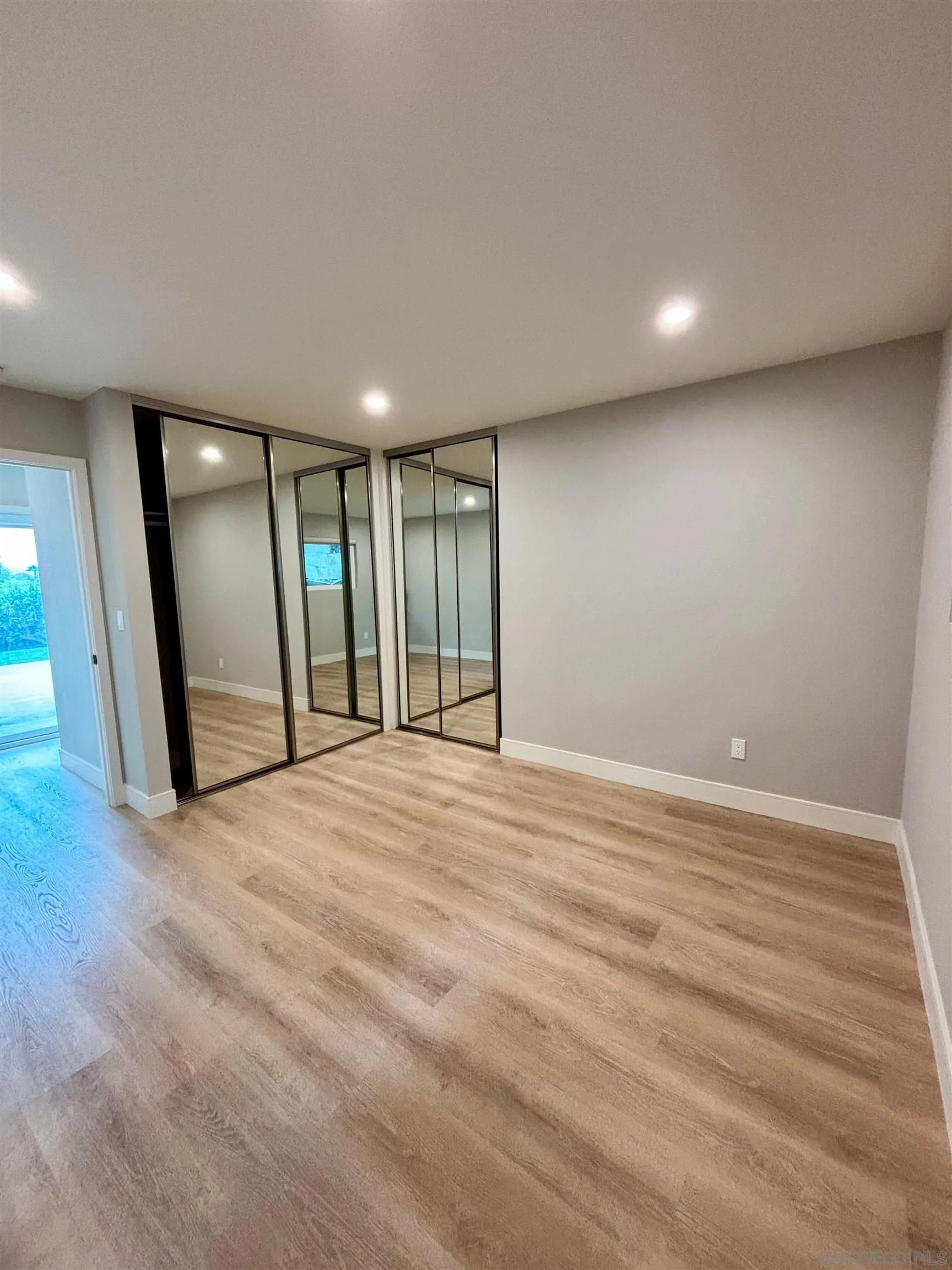 4856 Pacifica Drive San Diego, CA 92109 - Photo 16 of 32 a view of an empty room with wooden floor and a window