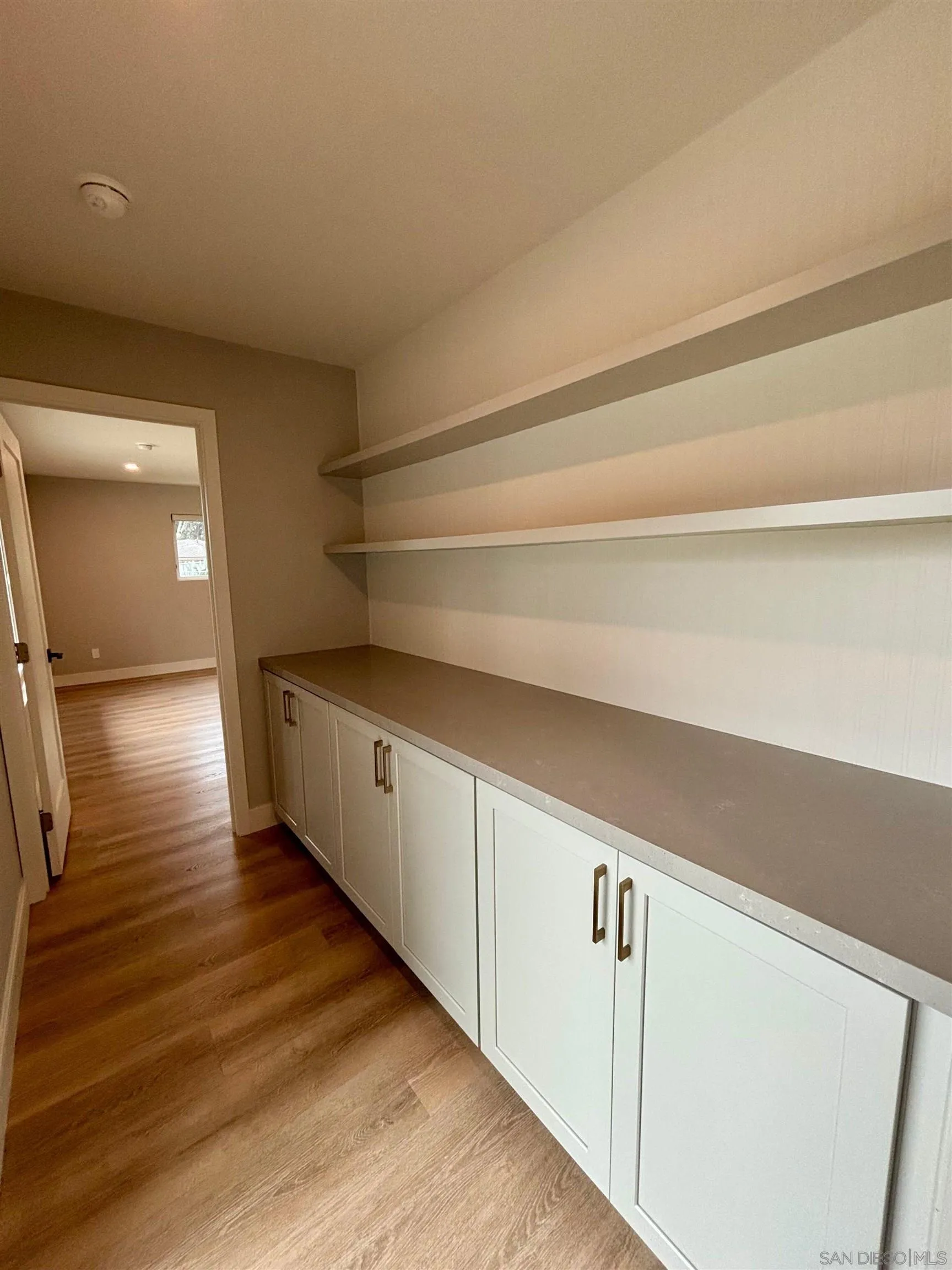 4856 Pacifica Drive San Diego, CA 92109 - Photo 19 of 32 a view of a hallway with wooden floor