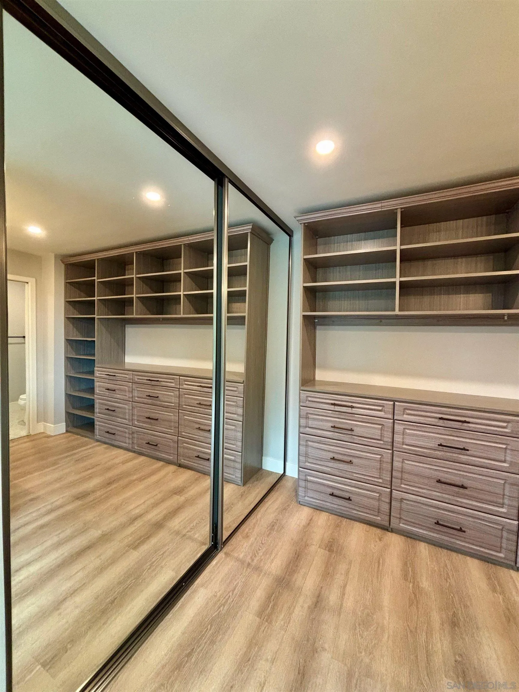4856 Pacifica Drive San Diego, CA 92109 - Photo 22 of 32 a view of an empty room with cabinet and a window