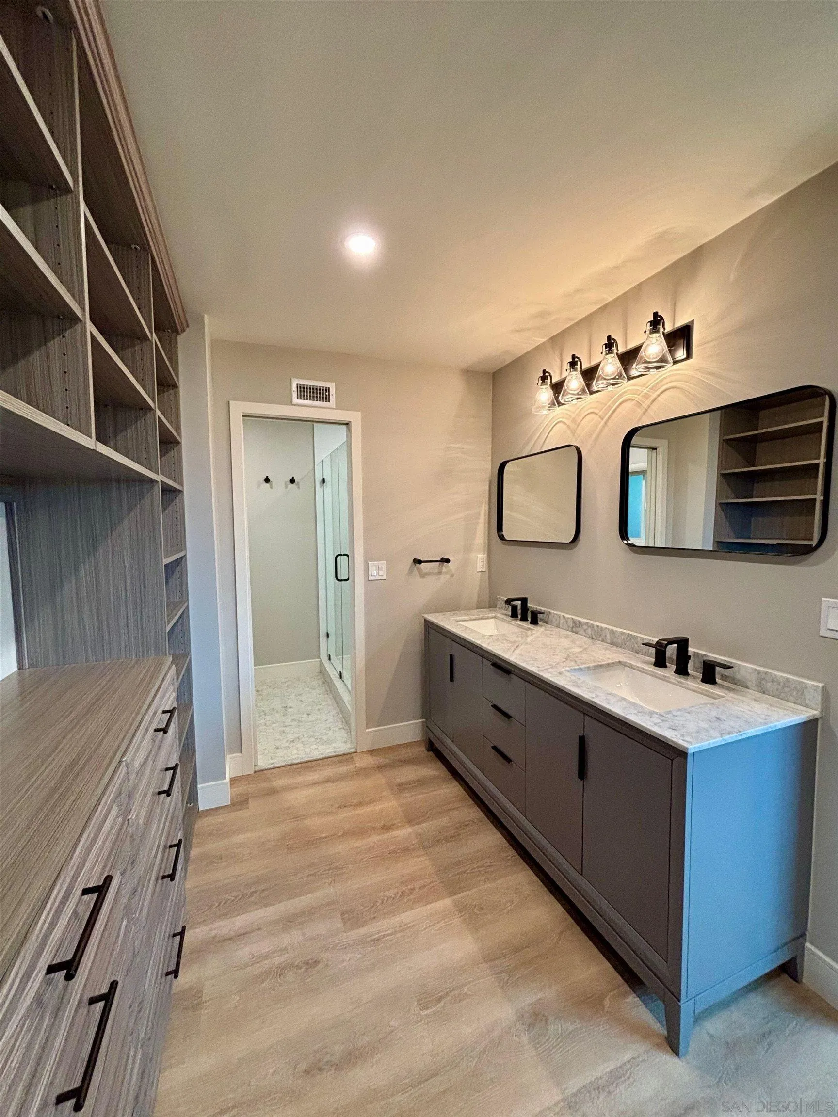 4856 Pacifica Drive San Diego, CA 92109 - Photo 24 of 32 a spacious bathroom with a double vanity sink mirror and