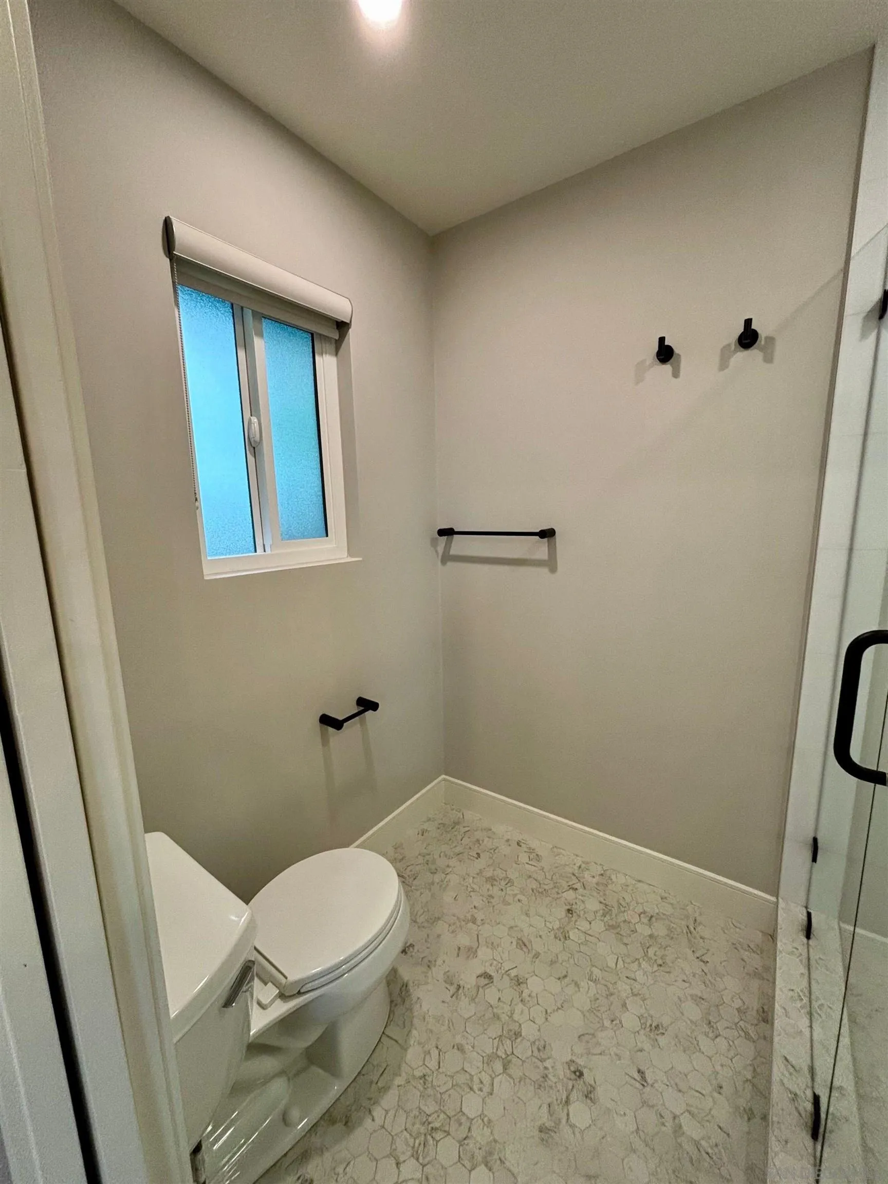 4856 Pacifica Drive San Diego, CA 92109 - Photo 25 of 32 a white toilet sitting next to a shower