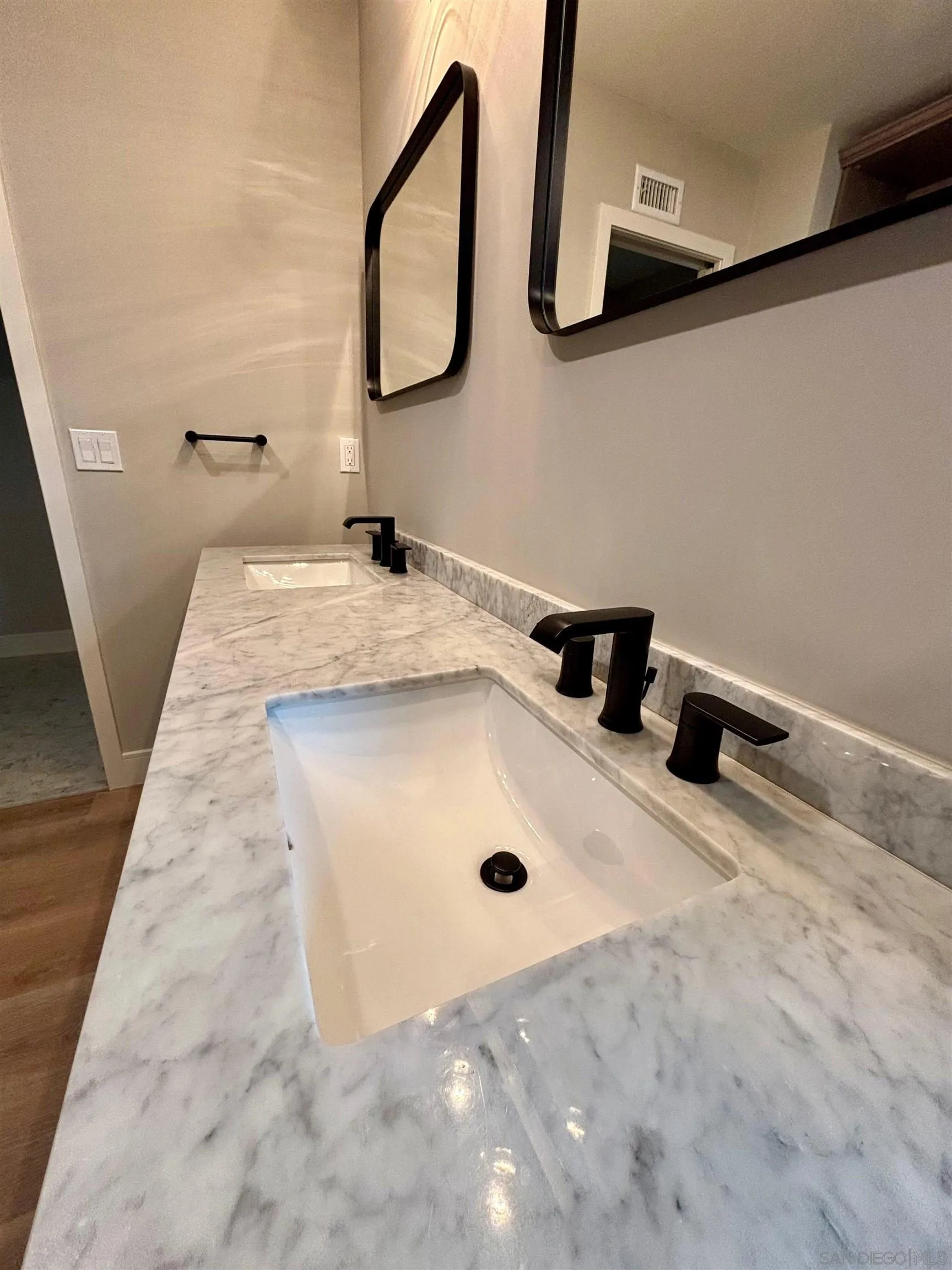 4856 Pacifica Drive San Diego, CA 92109 - Photo 27 of 32 a bathroom with a sink vanity and a mirror
