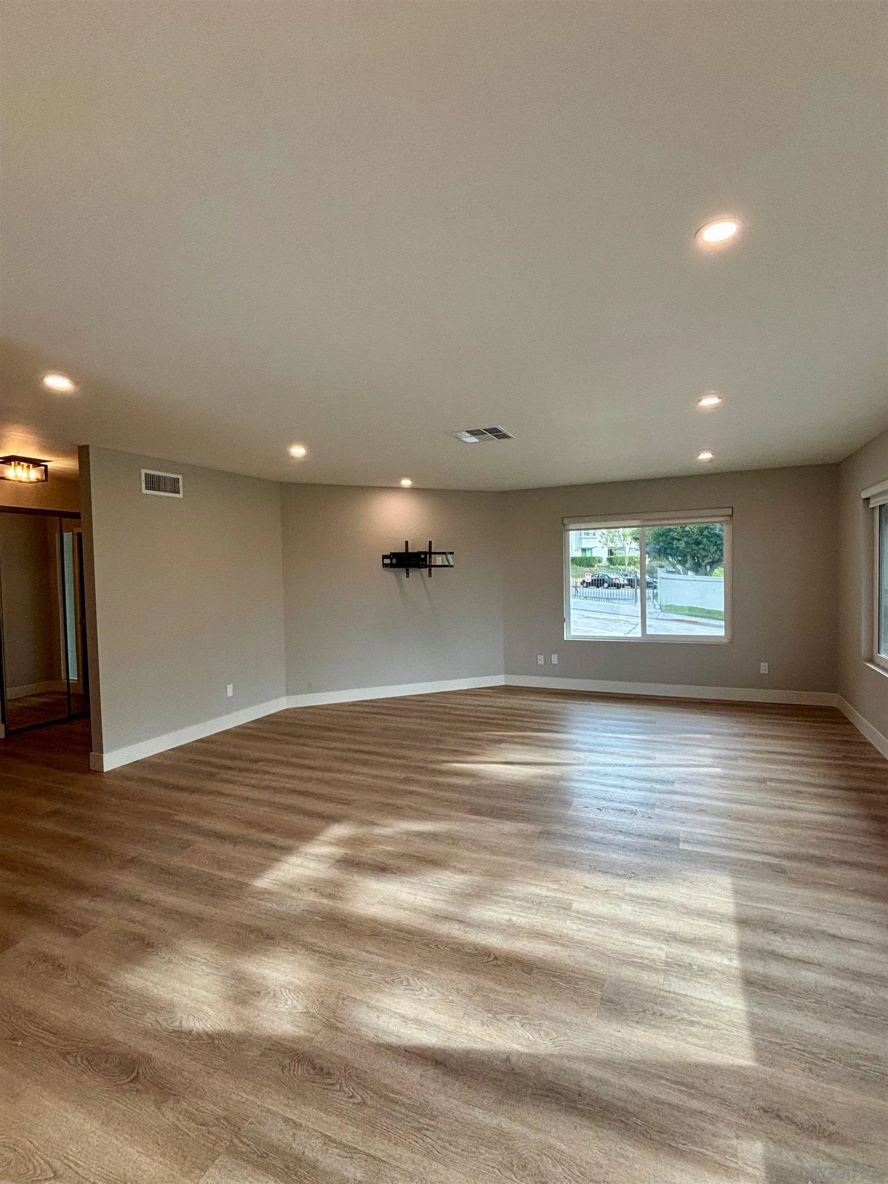 4856 Pacifica Drive San Diego, CA 92109 - Photo 3 of 32 a view of an empty room with wooden floor and a window