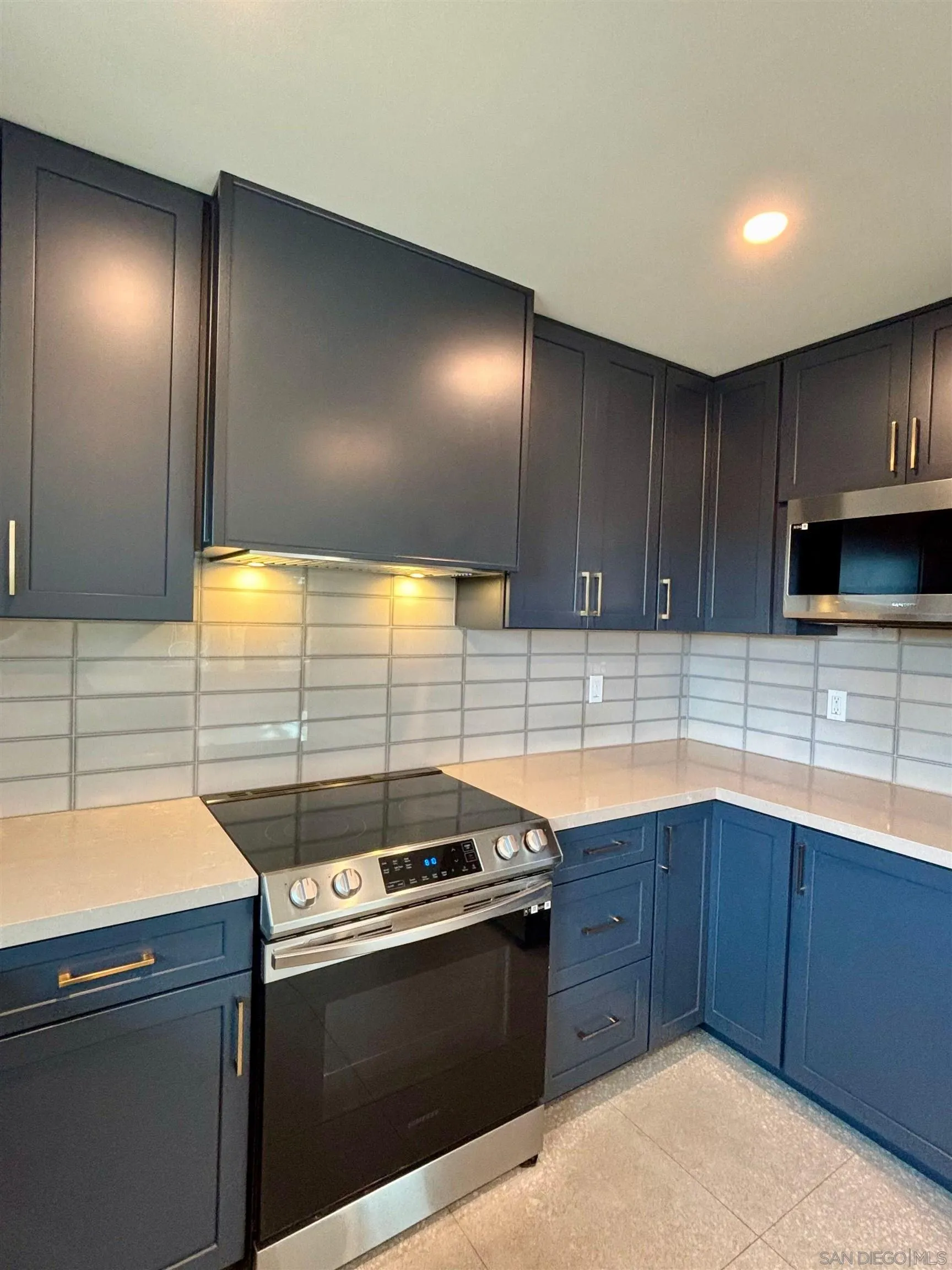 4856 Pacifica Drive San Diego, CA 92109 - Photo 8 of 32 a kitchen with a sink and cabinets