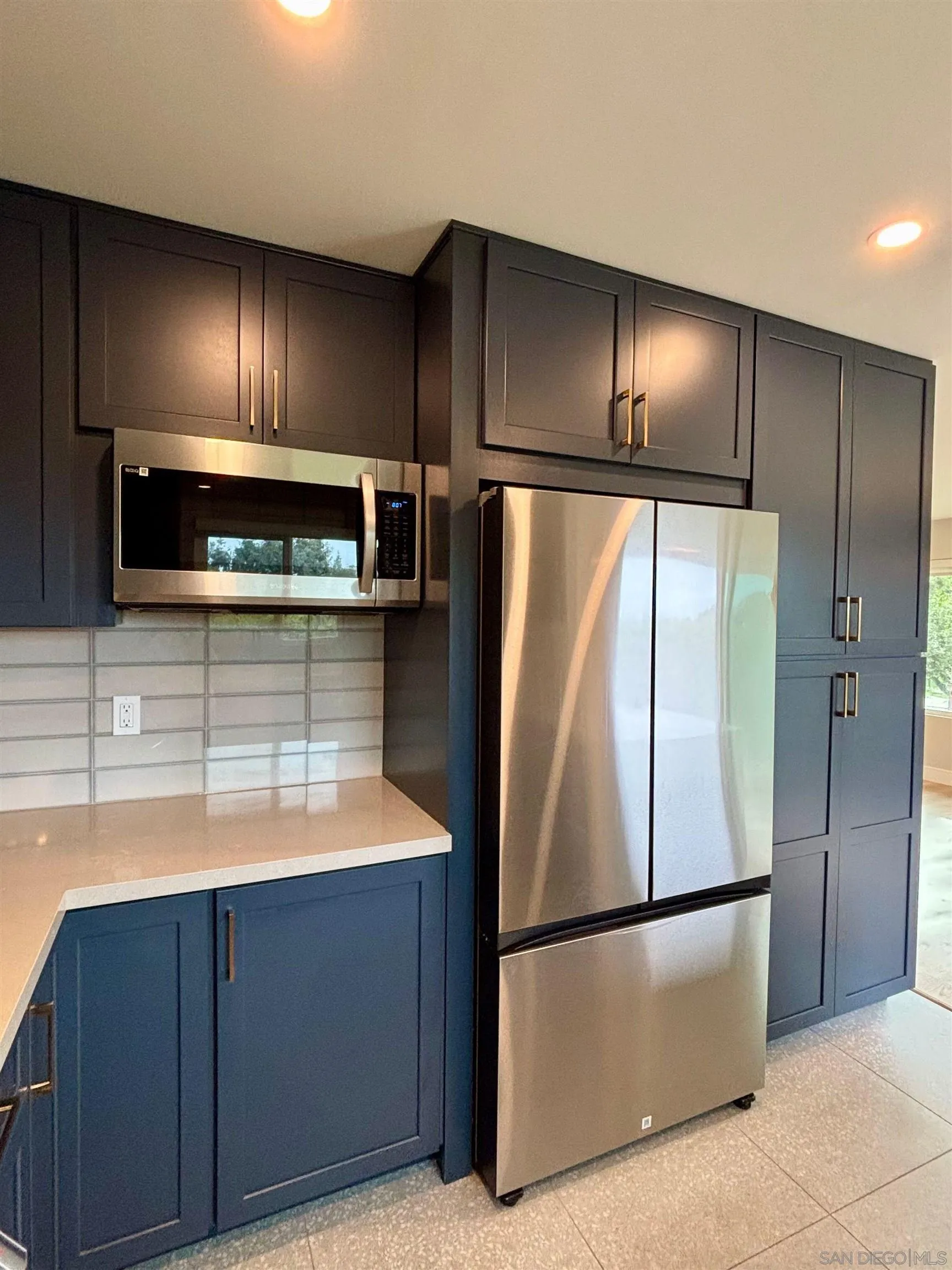 4856 Pacifica Drive San Diego, CA 92109 - Photo 9 of 32 a kitchen with cabinets and stainless steel appliances