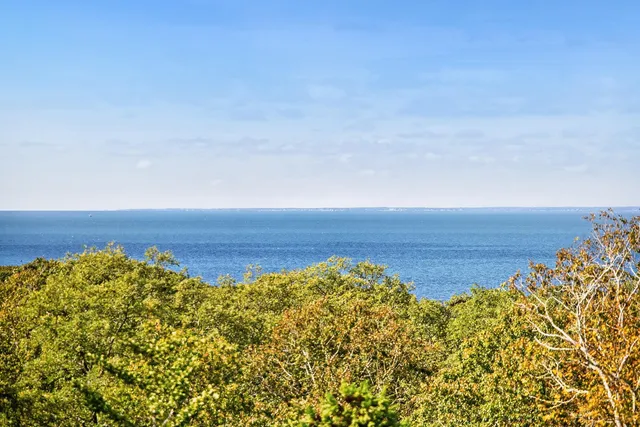 a bathroom with a granite countertop sink toilet and mirror