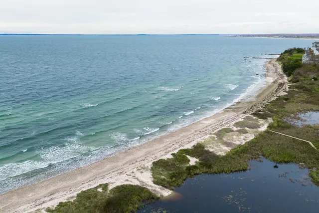 a living room with furniture a flat screen tv and a wooden floor