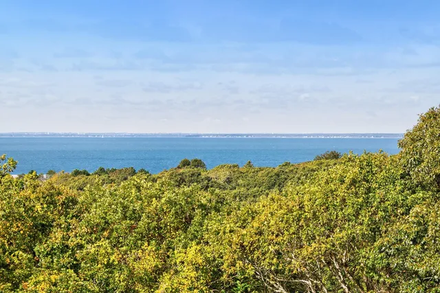 a view of a room with wooden floor and small window