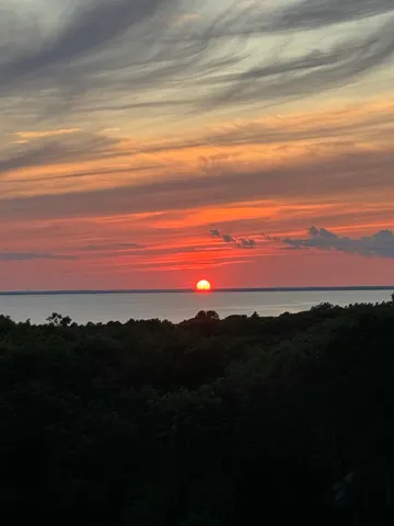 a bedroom with a bed and a balcony view